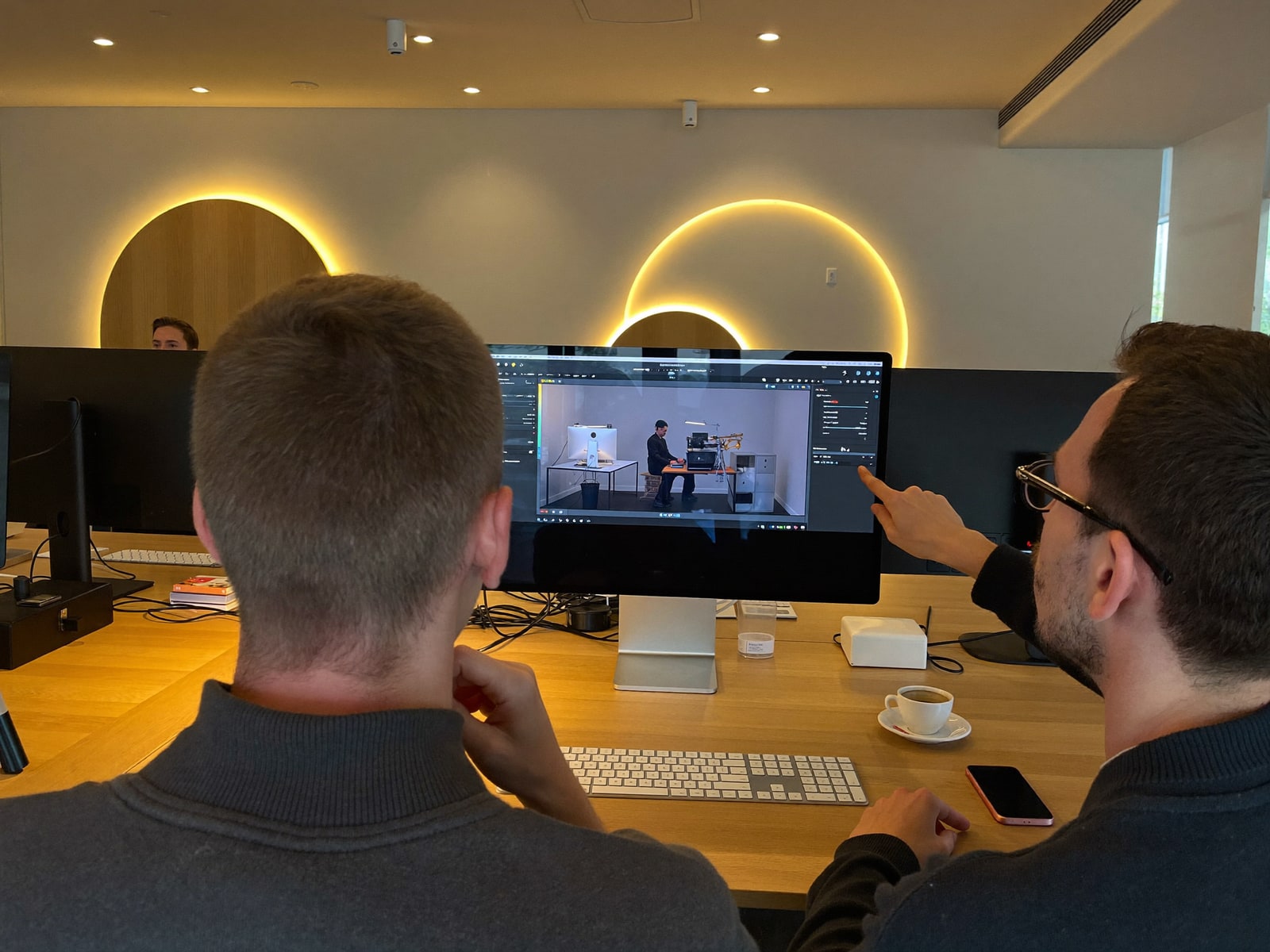 Two engineers reviewing a build on one screen